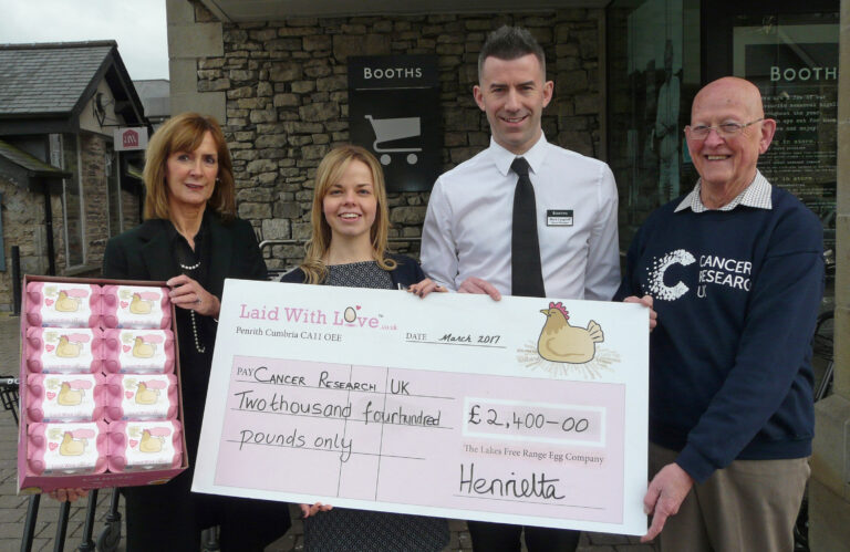 Laid with Love egg brand hands over charity cheque to Cancer Research
